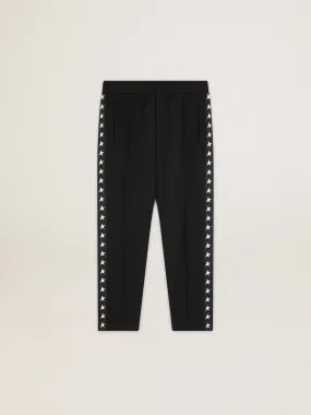 Men's black joggers with white stars on the sides