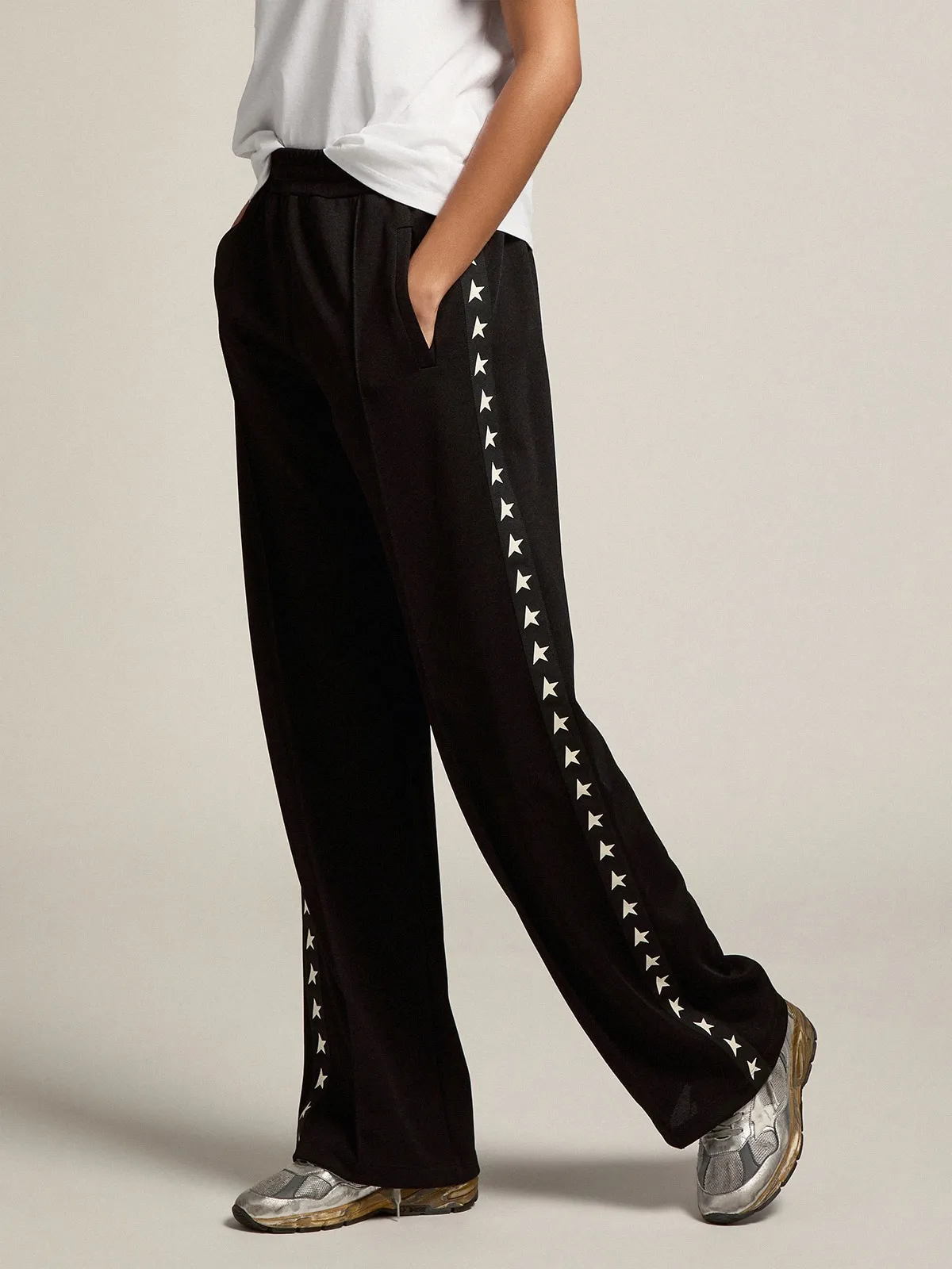 Women’s black joggers with white stars on the sides