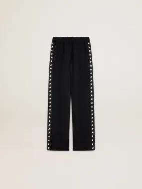 Women’s black joggers with white stars on the sides